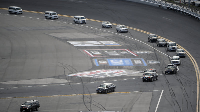 The motorcade with President Donald Trump makes its way through Turn 1 after arriving at Daytona International Airport before the NASCAR Daytona 500 auto race at Daytona International Speedway, Sunday, Feb. 16, 2020, in Daytona Beach, Fla. (AP Photo/Phelan M. Ebenhack)