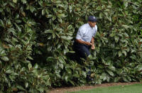 <p>Tiger Woods emerges from the bushes after hitting himself out on the fifth fairway during the first round of the Masters golf tournament at the Augusta National Golf Club in Augusta, Ga., Thursday, April 8, 2004. Woods double bogeyed the fifth hole. (AP Photo/David J. Phillip) </p>