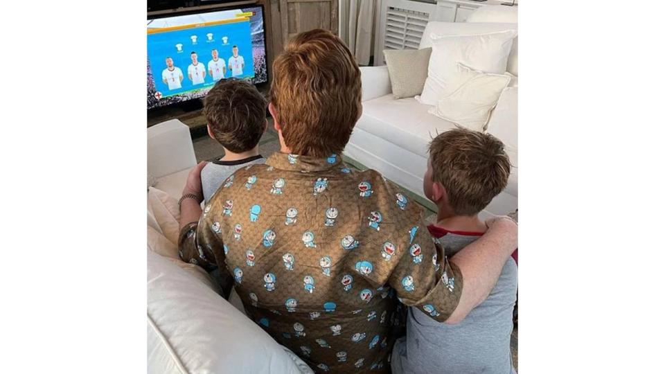 Elton John and his two sons watching football