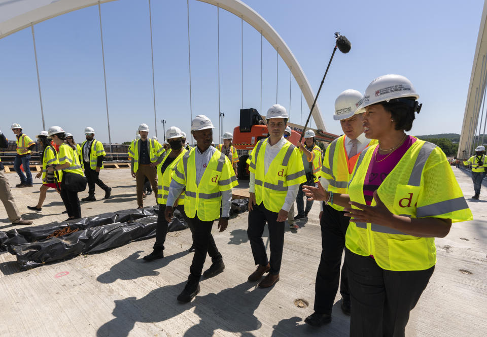 District of Columbia Mayor Muriel Bowser, from right, Secretary of Labor Marty Walsh, and Secretary of Transportation Pete Buttigieg, visit the Frederick Douglass Memorial Bridge construction site in southeast Washington, Wednesday, May 19, 2021. (AP Photo/Manuel Balce Ceneta)