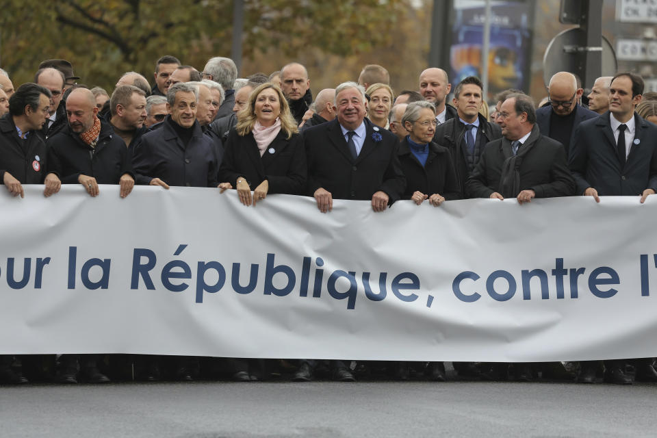 French Senate President Gerard Larcher, center, , President of the French National Assembly Yael Braun-Pivet, fourth left, French Prime Minister Elisabeth Borne third right, France's former President Francois Hollande, second right, President of the Representative Council of French Jewish Institutions (CRIF) Yonathan Arfi, right, and Former French prime minister stand behind a banner which reads as "For The Republic, Against anti-Semistism" a demonstration against anti-Semitism in Paris, Sunday, Nov. 12, 2023. (Thomas Samson/Pool via AP)