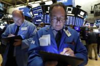 Trader Steven Kaplan, right, works on the floor of the New York Stock Exchange, Wednesday, June 19, 2019. Investors are in wait-and-see mode hours ahead of a widely anticipated Federal Reserve decision on interest rates. (AP Photo/Richard Drew)