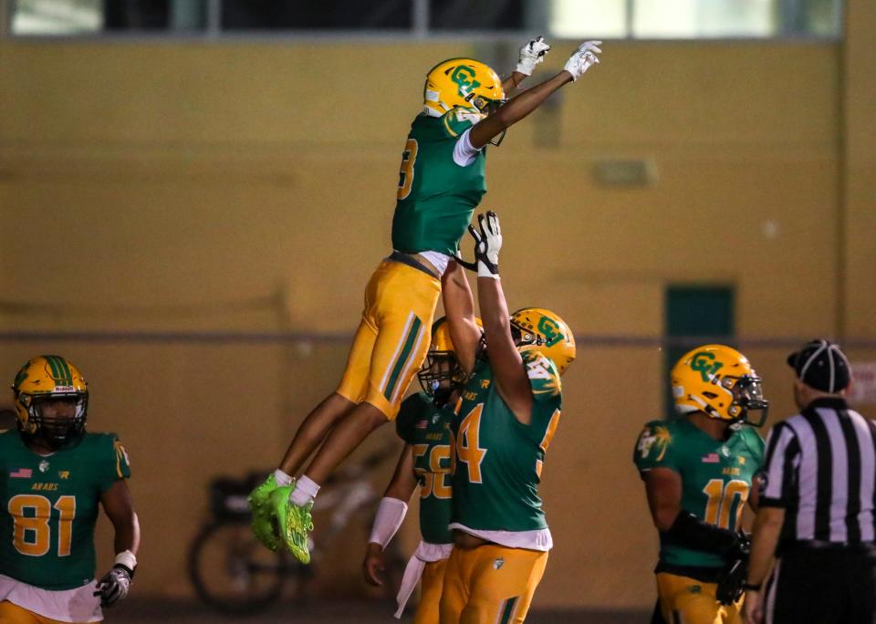 Coachella Valley's Ernesto Recio (3) is thrown in the air by Adolfo Valenzuela (54) in celebration of his 50-yard touchdown during the second quarter of their game at Coachella Valley High School in Thermal, Calif., Friday, Sept. 22, 2023.