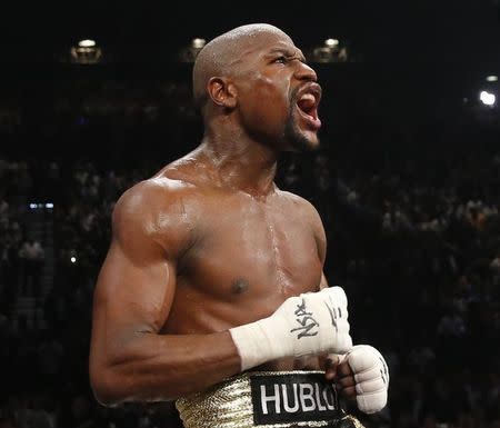 Floyd Mayweather, Jr. of the U.S. celebrates defeating Manny Pacquiao of the Philippines in a unanimous decision following their welterweight WBO, WBC and WBA (Super) title fight in Las Vegas, Nevada, May 2, 2015. REUTERS/Steve Marcus