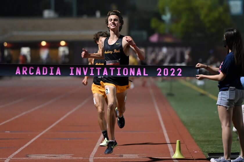 Newbury Park's Colin Sahlman crosses the finish line, winning a boys' 3200 meter race