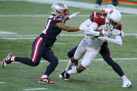 New England Patriots cornerback Jason McCourty, rear, tackles Arizona Cardinals wide receiver KeeSean Johnson short of the goal line near the end fo the first half of an NFL football game, Sunday, Nov. 29, 2020, in Foxborough, Mass. (AP Photo/Charles Krupa)