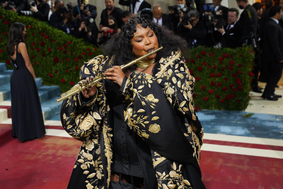 Lizzo playing the flute on the red carpet