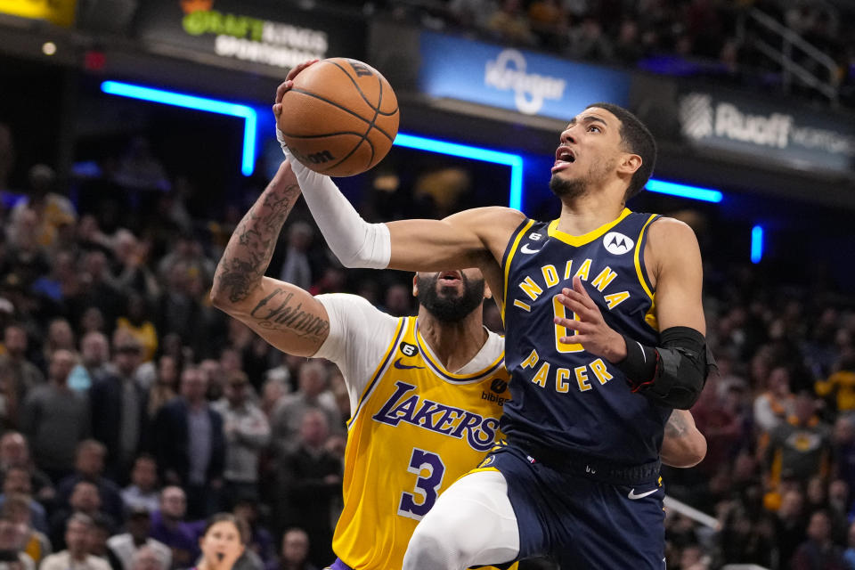 Indiana Pacers guard Tyrese Haliburton (0) shoots in front of Los Angeles Lakers forward Anthony Davis (3) during the second half of an NBA basketball game in Indianapolis, Thursday, Feb. 2, 2023. The Lakers defeated the Pacers 112-111. (AP Photo/Michael Conroy)