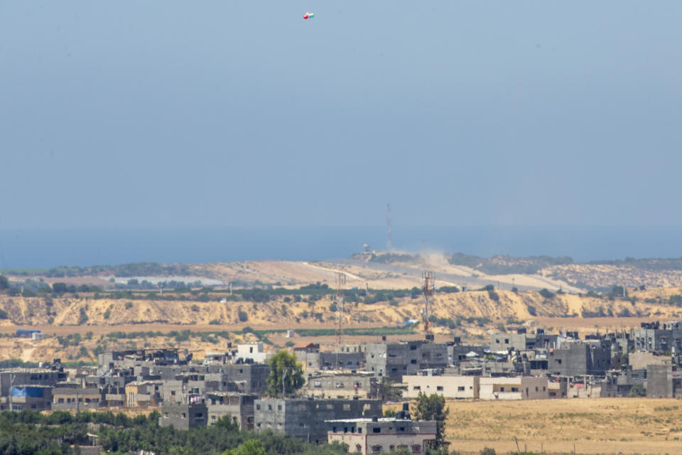 Balloons carrying an incendiary device launched from the Gaza Strip drift to the Israeli side of the border between Gaza and Israel, Monday, Aug. 24, 2020. Militants affiliated with Hamas have launched scores of incendiary balloons into southern Israel in recent weeks in a bid to pressure Israel to ease the blockade imposed since Hamas took control of the territory in 2007. The Israeli military said it struck militant targets in the Gaza Strip early on Monday, in response to the balloons. (AP Photo/Ariel Schalit)