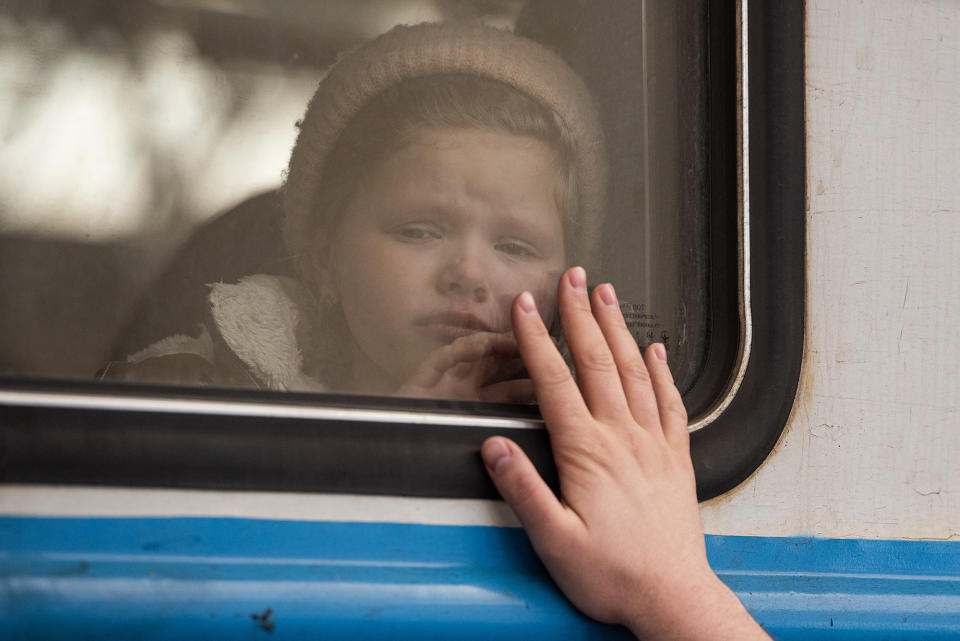 A young girl cries on a departing train at a railway station in Lviv, Ukraine, on March 22, 2022. Lviv has served as a stopover and shelter for the millions of Ukrainians fleeing the Russian invasion, either to the safety of nearby countries or the relative security of western Ukraine.
