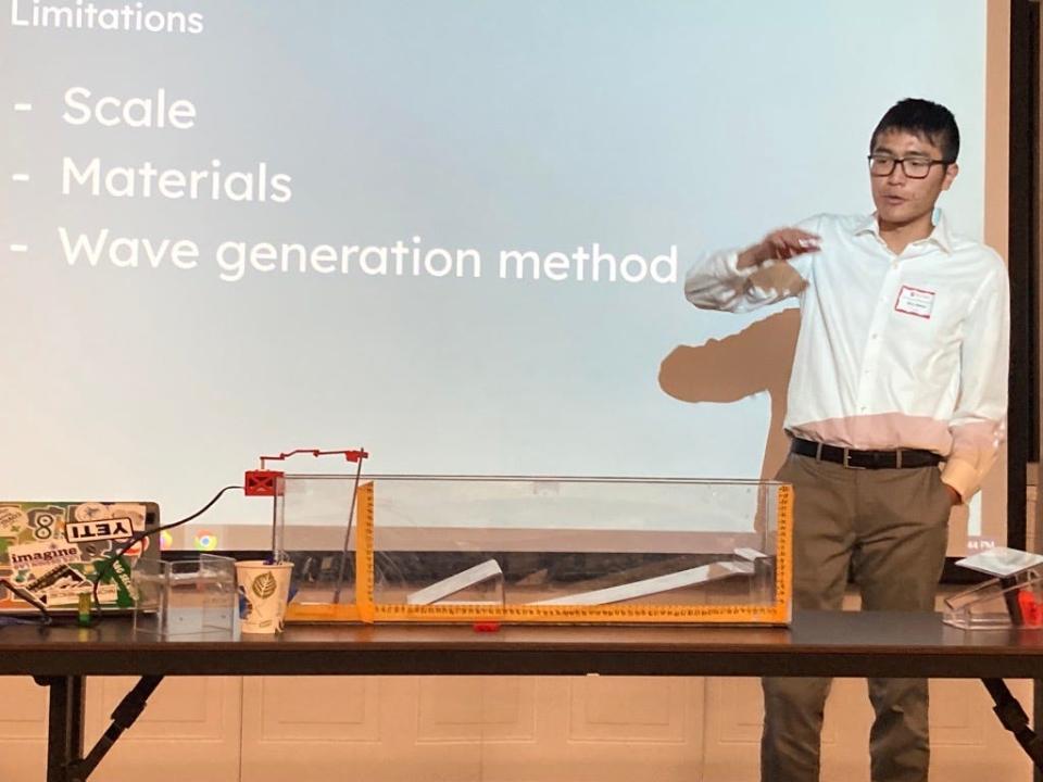 Bill Wang, high school senior, demostrates a breakwave model at Rutgers University