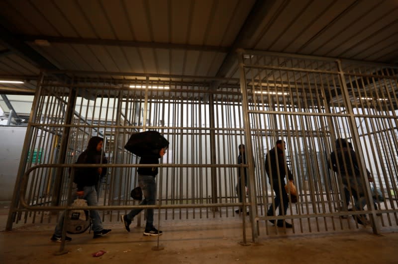 Palestinians working in Israel head to work through an Israeli checkpoint near Ramallah in the Israeli-occupied West Bank