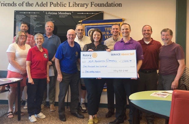Adel Rotary members present a $1,200 check to Meadow View Elementary Principal Jodi Banse at its May 31 meeting for the school's book vending machine.