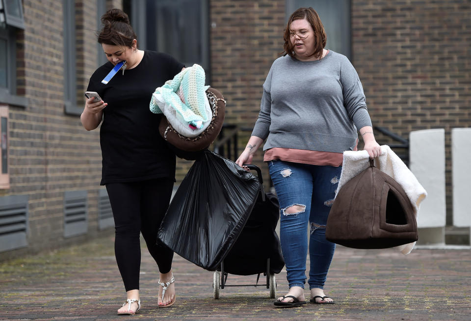 <p>People carry personal possessions as they leave the Dorney Tower residential block, as residents were evacuated as a precautionary measure following concerns over the type of cladding used on the outside of the buildings on the Chalcots Estate in north London, Britain, June 25, 2017. (Photo: Hannah McKay/Reuters) </p>