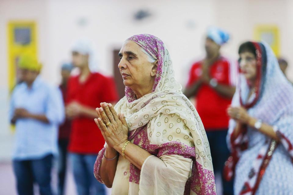A women perform a prayer during a special prayer for passengers onboard the missing Malaysia Airlines Flight MH370 inside the Sikh temple in Kuala Lumpur March 20, 2014.