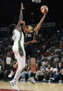 Las Vegas Aces guard Kelsey Plum (10) shoots around Seattle Storm's Tina Charles during the first half in Game 1 of a WNBA basketball semifinal playoff series Sunday, Aug. 28, 2022, in Las Vegas. (AP Photo/John Locher)