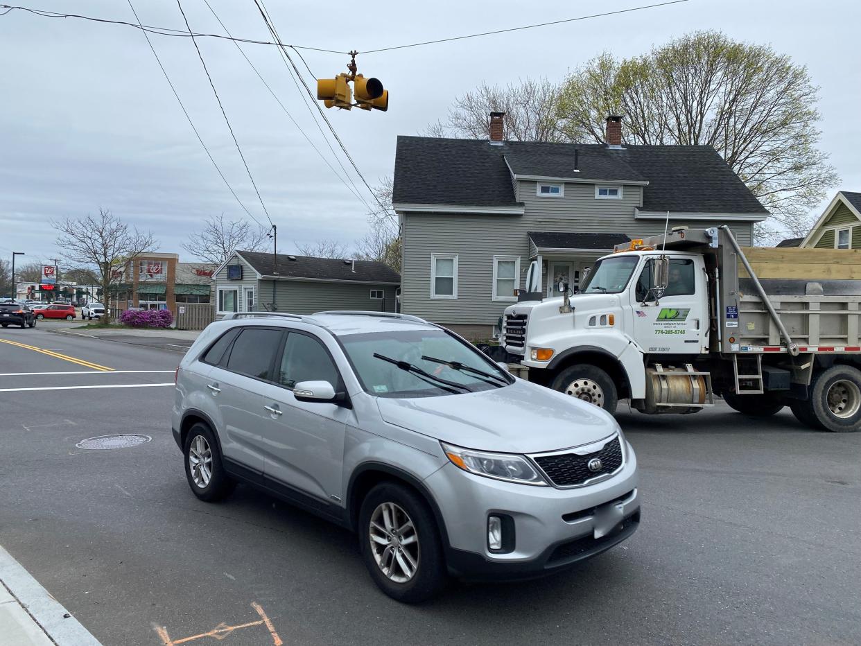 A commercial truck nudges its way across East Britannia Street as a car drives by on Washington Street on Thursday, April 18, 2024.