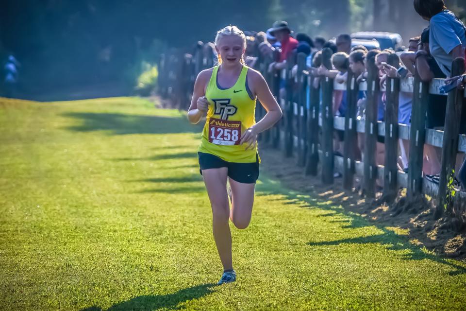 Fort Payne's Kyndal Hughes comes in first place at the Pisgah Invitational large school girls cross country race.