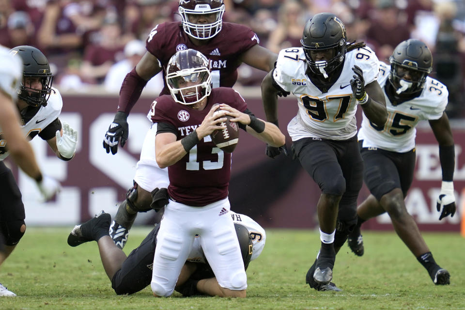 Texas A&M quarterback Haynes King (13) is tackled by Appalachian State linebacker Nick Hampton (9) on Saturday, Sept. 10, 2022, in College Station, Texas. (AP Photo/Sam Craft)