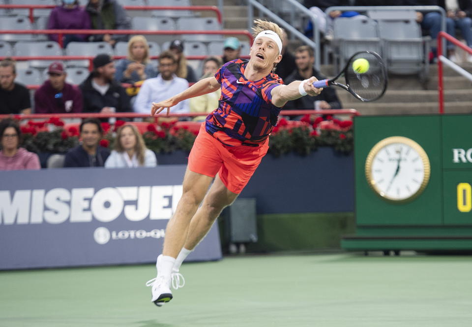 Denis Shapovalov, of Canada, lunges for the ball during his first-round match against Alex de Minaur, of Australia, at the National Bank Open tennis tournament in Montreal, Monday, Aug. 8, 2022. (Graham Hughes/The Canadian Press via AP)