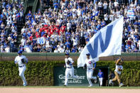 Chicago Cubs outfielders from left, Ian Happ, Seiya Suzuki, and Cody Bellinger run to celebrate with teammate the Cubs 4-2 win over the Miami Marlins in a baseball game on Saturday, May 6, 2023, in Chicago. (AP Photo/Charles Rex Arbogast)