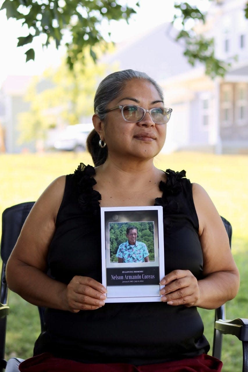 Teresa Coreas, a cafeteria worker at Timothy Road Elementary School, holds a photo of her husband, who died recently of a rare and incurable disease.