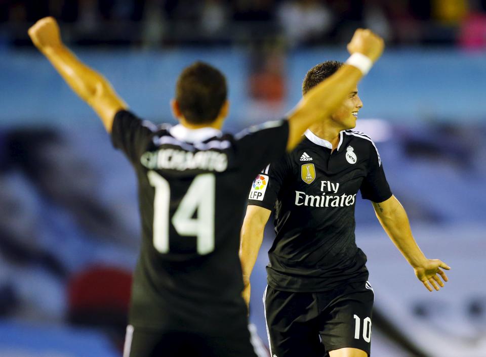 Real Madrid's James Rodriguez (R) celebrates his goal against Celta Vigo with teammate Javier Hernandez "Chicharito" during their Spanish first division soccer match at Balaidos stadium in Vigo April 26, 2015. REUTERS/Miguel Vidal