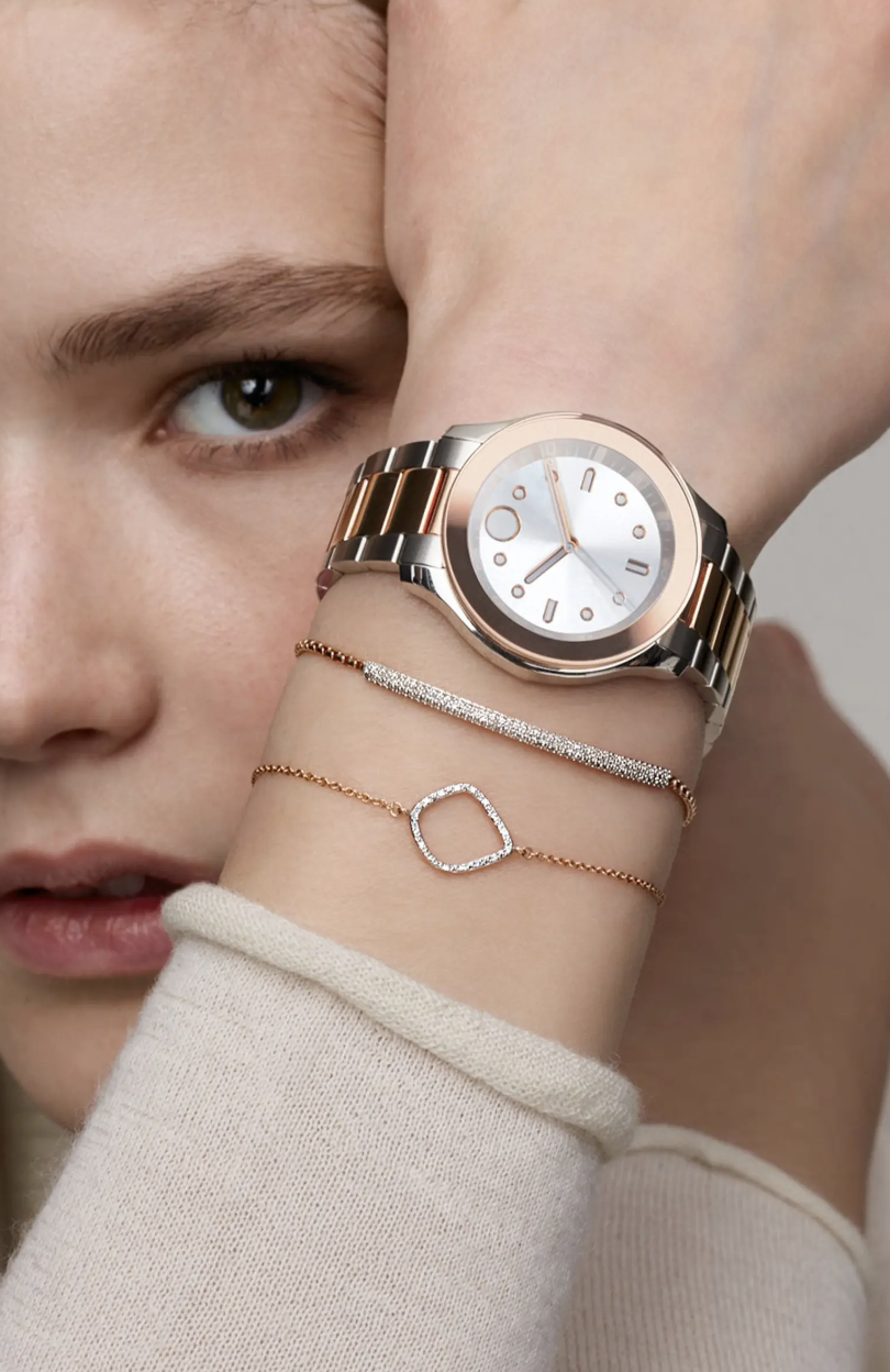 woman wearing beige sweater holding up hand with watch and diamond bracelets, Monica Vinader Riva Kite Adjustable Diamond Bracelet (Photo via Nordstrom)