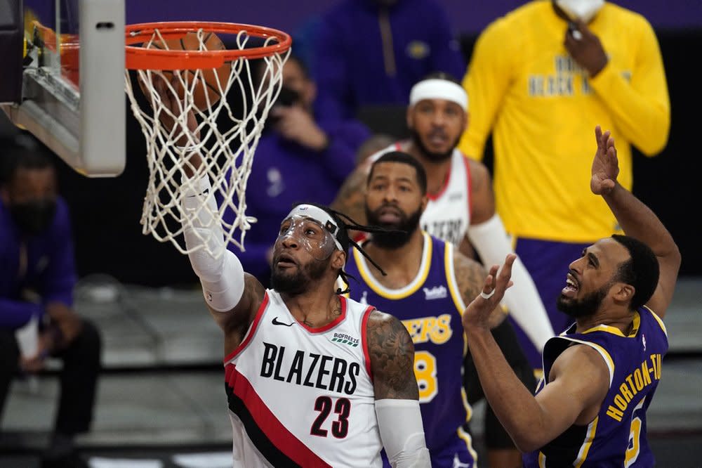 Portland Trail Blazers forward Robert Covington (23) shoots against Los Angeles Lakers guard Talen Horton-Tucker (5) during the second half of an NBA basketball game Friday, Feb. 26, 2021, in Los Angeles. (AP Photo/Mark J. Terrill)