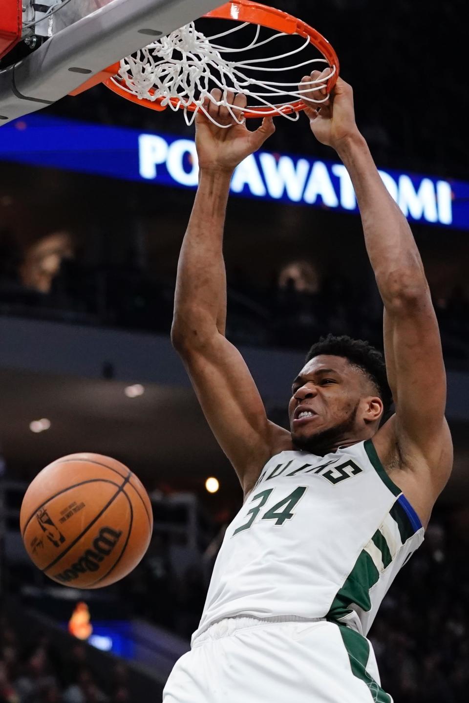 Milwaukee Bucks' Giannis Antetokounmpo dunks during the first half of an NBA basketball game Sunday, March 6, 2022, in Milwaukee . (AP Photo/Morry Gash)