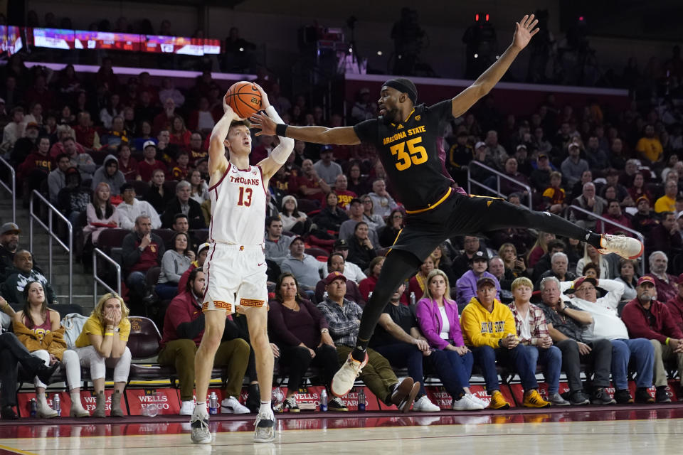 Southern California guard Drew Peterson (13) shoots against Arizona State guard Devan Cambridge (35) during the second half of an NCAA college basketball game Saturday, March 4, 2023, in Los Angeles. (AP Photo/Marcio Jose Sanchez)