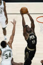 Atlanta Hawks center Clint Capela (15) scores as Milwaukee Bucks forward Giannis Antetokounmpo (34) defends during the first half of an NBA basketball game Thursday, April 15, 2021, in Atlanta. (AP Photo/John Bazemore)