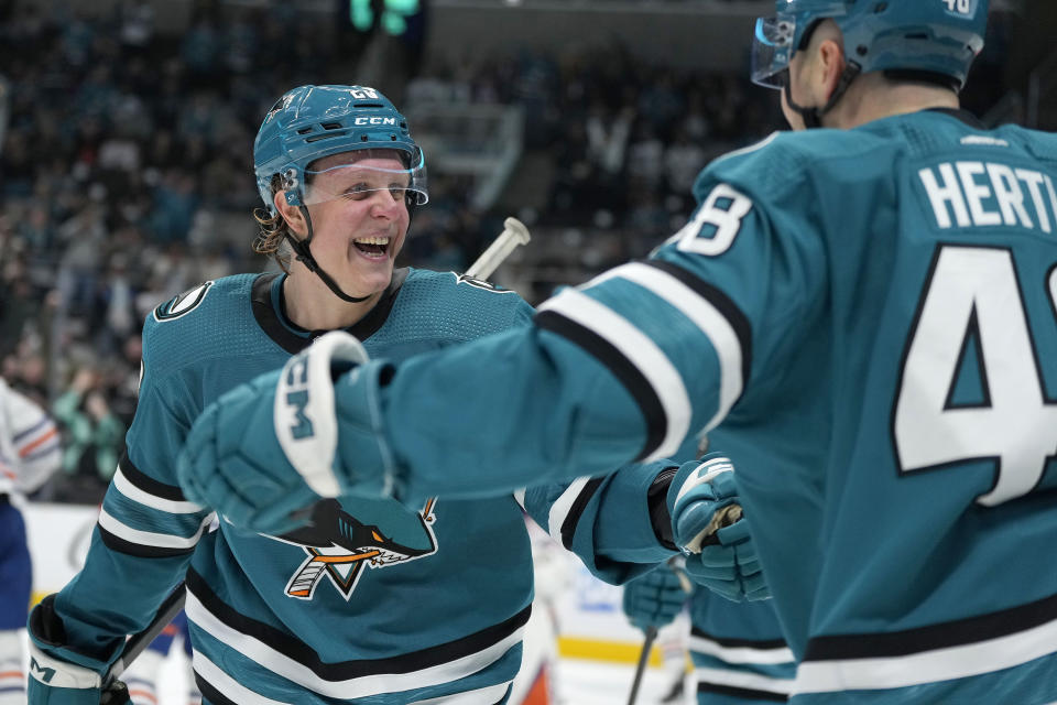 San Jose Sharks left wing Fabian Zetterlund, left, celebrates with Tomas Hertl (48) after scoring a goal against the Edmonton Oilers during the first period of an NHL hockey game Thursday, Nov. 9, 2023, in San Jose, Calif. (AP Photo/Tony Avelar)