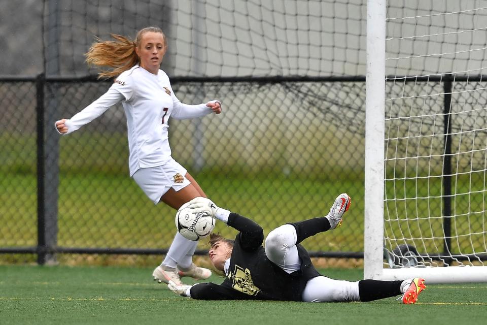 Arlington goalie Kayla Kalbaugh makes a save as Cora Kraft covers the play during a NYSPHSAA Class AA semifinal against Shenendehowa-II in Cortland Saturday, Nov. 13, 2021.
