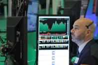 FILE PHOTO: A trader works on the floor of the New York Stock Exchange shortly before the closing bell in New York