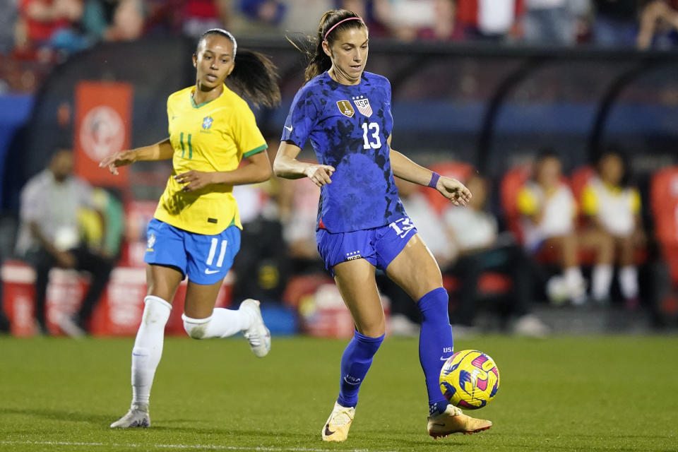 United States forward Alex Morgan (13) controls the ball in front of Brazil midfielder Adriana (11) during the first half of a SheBelieves Cup soccer match Wednesday, Feb. 22, 2023, in Frisco, Texas. (AP Photo/LM Otero)