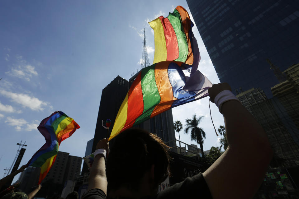 Revelers wave rainbow flags during the annual gay pride parade along Paulista avenue in Sao Paulo, Brazil, Sunday, June 23, 2019. (AP Photo/Nelson Antoine)