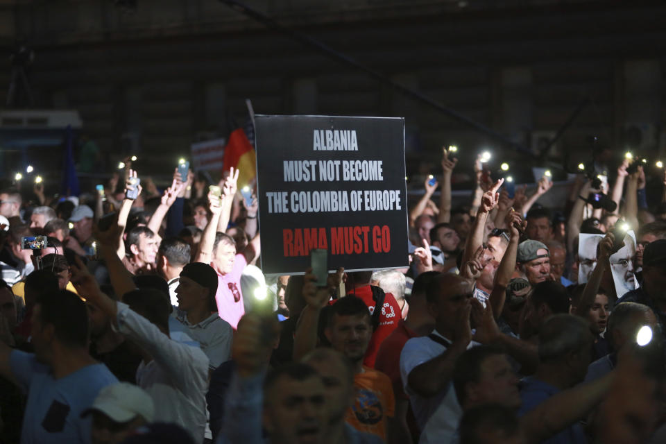 Demonstrator gather during an anti-government protest in Tirana, Albania, Saturday, June 8, 2019. Thousands of Albanian opposition supporters are gathering in an anti-government protest while the United States and the European Union caution their leaders to disavow violence and sit in a dialogue to overcome the political crisis. (AP Photo/Hektor Pustina)