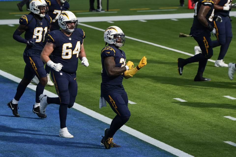 Los Angeles Chargers running back Kalen Ballage, center, reacts after scoring a touchdown during the first half of an NFL football game against the Las Vegas Raiders, Sunday, Nov. 8, 2020, in Inglewood, Calif. (AP Photo/Ashley Landis)