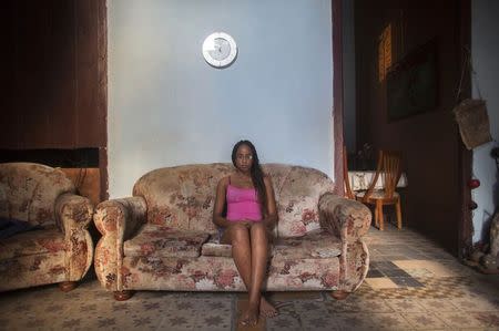 Medical student Ashley Perez, 18, poses for a photograph while sitting in the living room of her home in Havana January 6, 2015. REUTERS/Alexandre Meneghini