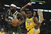 Milwaukee Bucks' Patrick Beverley rebounds in front of Indiana Pacers' Aaron Nesmith during the first half of Game 2 of the NBA playoff basketball game Tuesday, April 23, 2024, in Milwaukee. (AP Photo/Morry Gash)