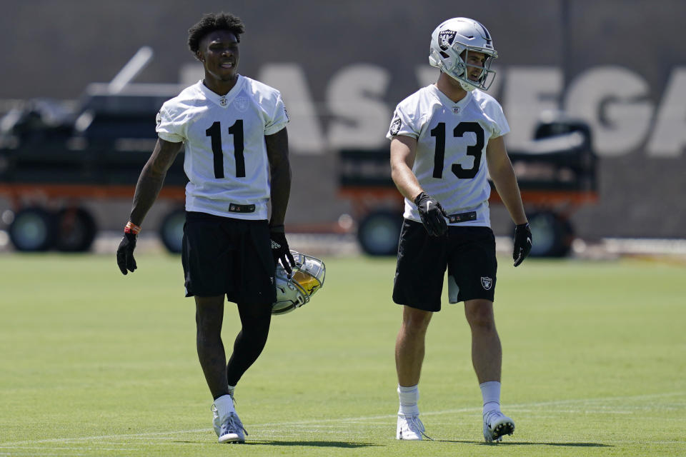 Las Vegas Raiders wide receiver Henry Ruggs III (11) and wide receiver Hunter Renfrow (13) walk down the field during NFL football practice Wednesday, June 2, 2021, in Henderson, Nev. (AP Photo/John Locher)