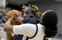 UConn's Aaliyah Edwards collides with Providences' Janai Crooms, right, under the net during the first half of an NCAA college basketball game, Wednesday, Feb. 1, 2023, in Providence, R.I. (AP Photo/Mark Stockwell)