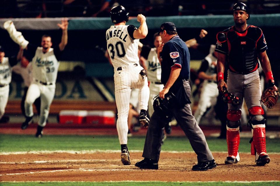 Craig Counsell scores in the bottom of the 11th inning of Game 7 and the celebration begins as the Marlins edged the Indians 3-2 to win the franchise's first World Series title in October 1997.