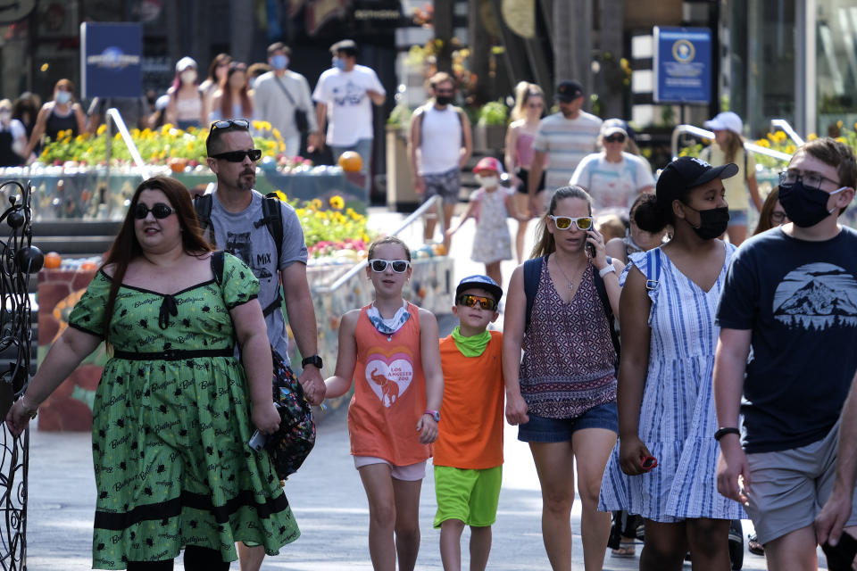 People arrive at Universal Studios in Universal City, Calif., Tuesday, June 15, 2021. On Tuesday, California lifted most of its COVID-19 restrictions and ushered in what has been billed as the state’s “Grand Reopening.” (AP Photo/Ringo H.W. Chiu)