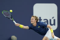 Sebastian Korda returns a shot from Radu Albot, of Moldova, during a tennis match during the Miami Open tennis tournament Thursday, March 25, 2021, in Miami Gardens, Fla. (AP Photo/Wilfredo Lee)