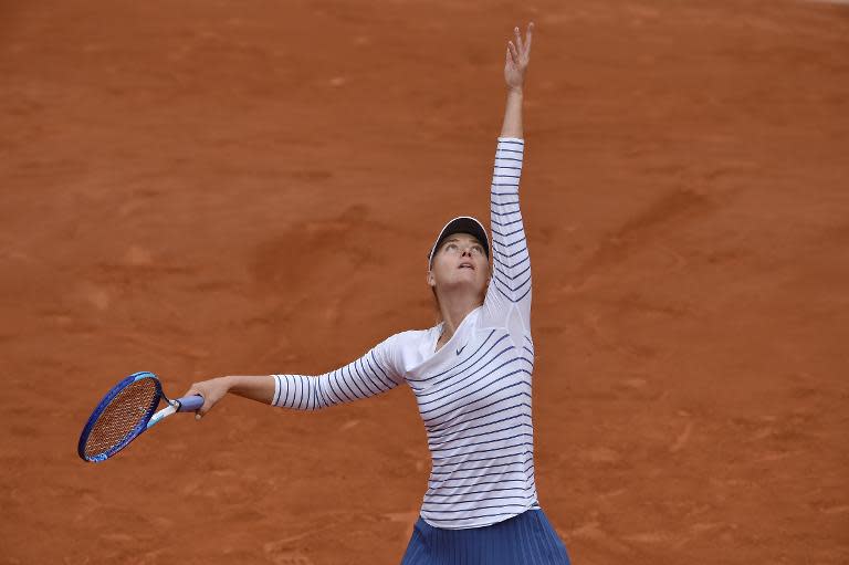 Russia's Maria Sharapova serves to Australia's Samantha Stosur during the women's third round at the Roland Garros 2015 French Tennis Open in Paris on May 29, 2015