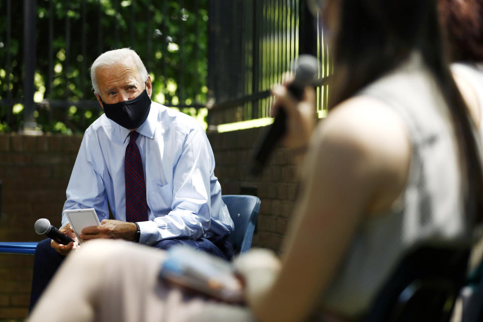 Democratic presidential candidate, former Vice President Joe Biden, left, listens to Laura Raslevich, of Pittsburgh, during a meeting with families who have benefited from the Affordable Care Act, Thursday, June 25, 2020, in Lancaster, Pa. (AP Photo/Matt Slocum)