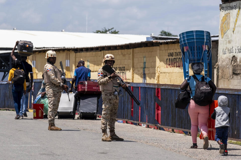 Dominican Republic security forces stand guard on a border bridge between Dajabón, Dominican Republic, and Haiti, Thursday, Sept. 14, 2023. The president of the Dominican Republic announced Thursday that he would close all borders with neighboring Haiti starting Friday in response to the construction of a supposed canal on Haitian soil that targets waters from the Massacre River, which runs along the border shared by both countries. (AP Photo/Ricardo Hernández)