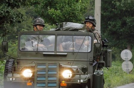 A South Korean armed military vehicle transporting soldiers travels near the demilitarised zone separating the two Koreas in Paju, South Korea, August 10, 2017. REUTERS/Kim Hong-Ji